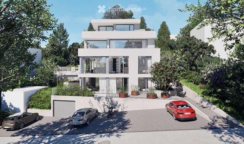 Modern two-story house with white exterior, large windows, and a balcony on the upper level. The house features a garage and a parking area with several cars.