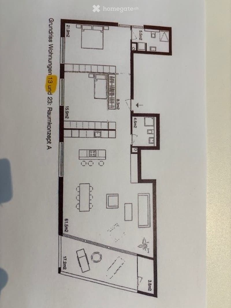 Floor plan of a residential unit showing a living room, dining area, kitchen, three bedrooms, and two bathrooms.