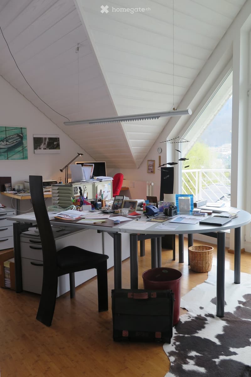 {"type": "Furnished Room", "objects": ["chair", "table", "laptop", "laptop", "framed picture", "framed picture", "framed picture", "framed picture", "framed picture", "framed picture", "framed picture", "framed picture", "framed picture", "framed picture"