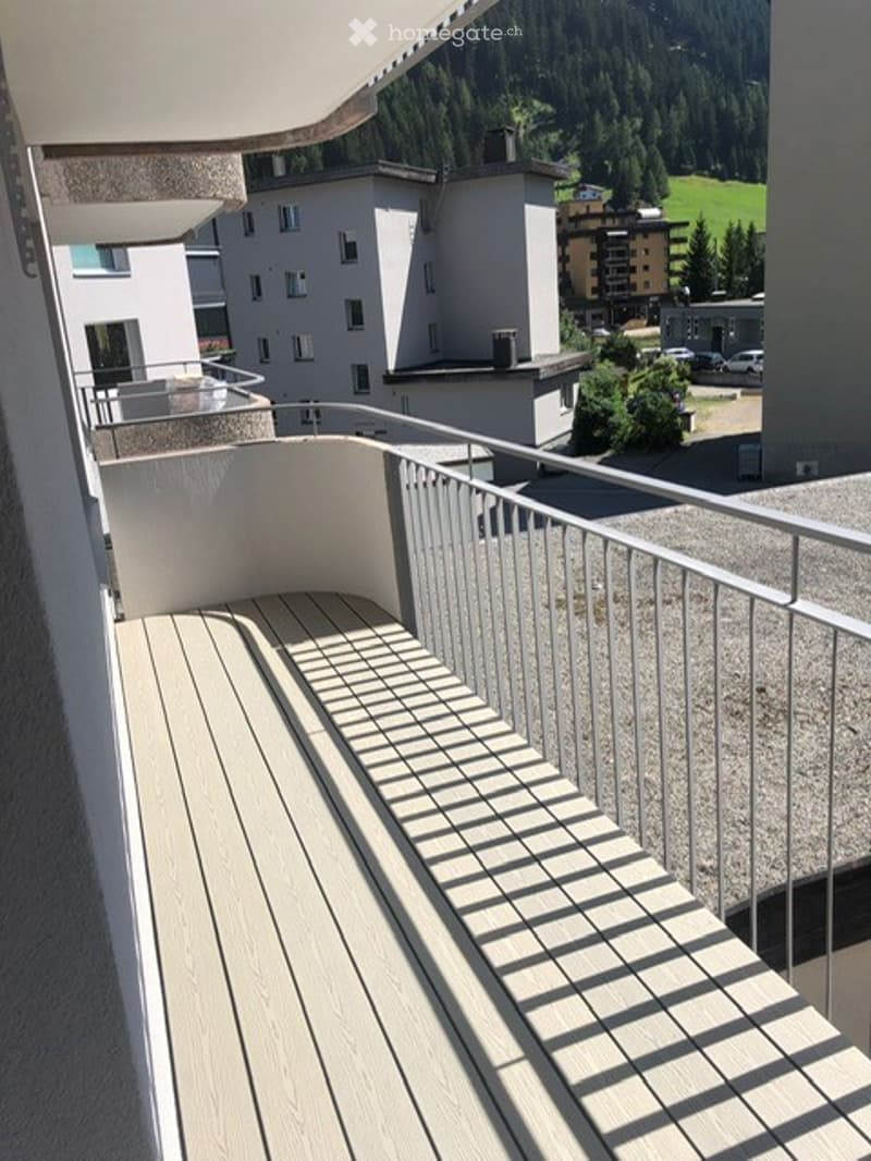 covered balcony with wooden floor, metal railings, and a view of the mountains