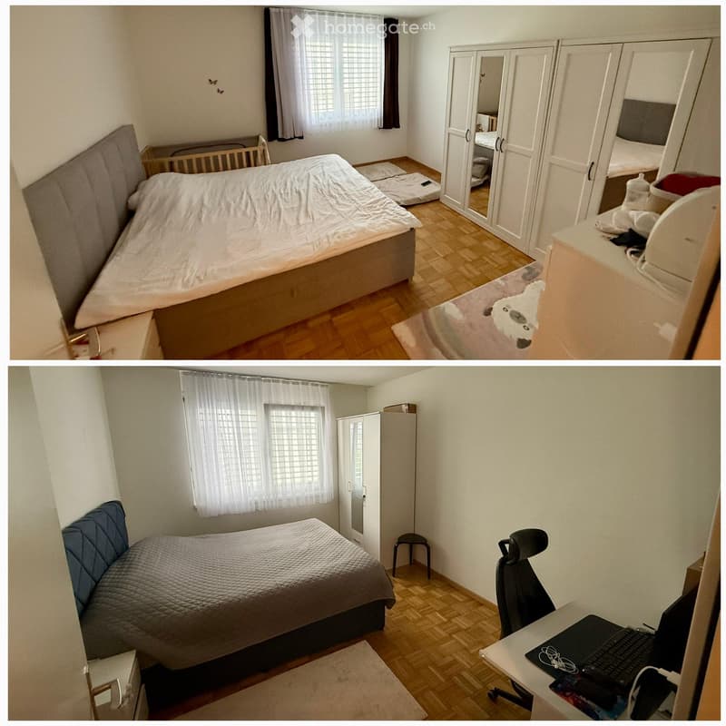 A furnished bedroom with a bed, wardrobe, desk, chair, and laptop. The room features wooden flooring and a window with white curtains.