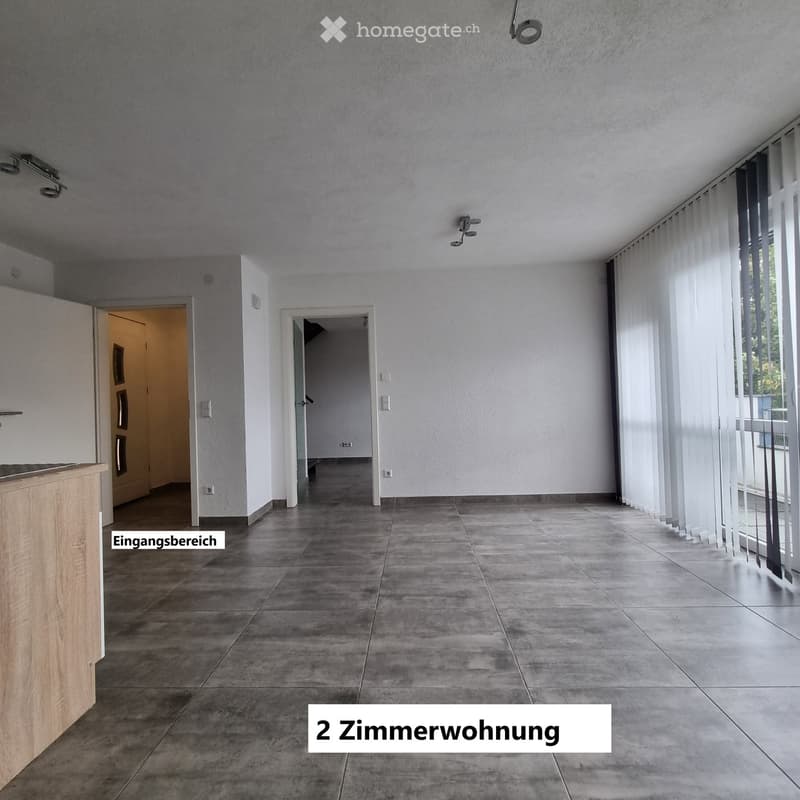 Empty hallway with tiled floor, white walls, and large windows with blinds. Two doors lead to other rooms.