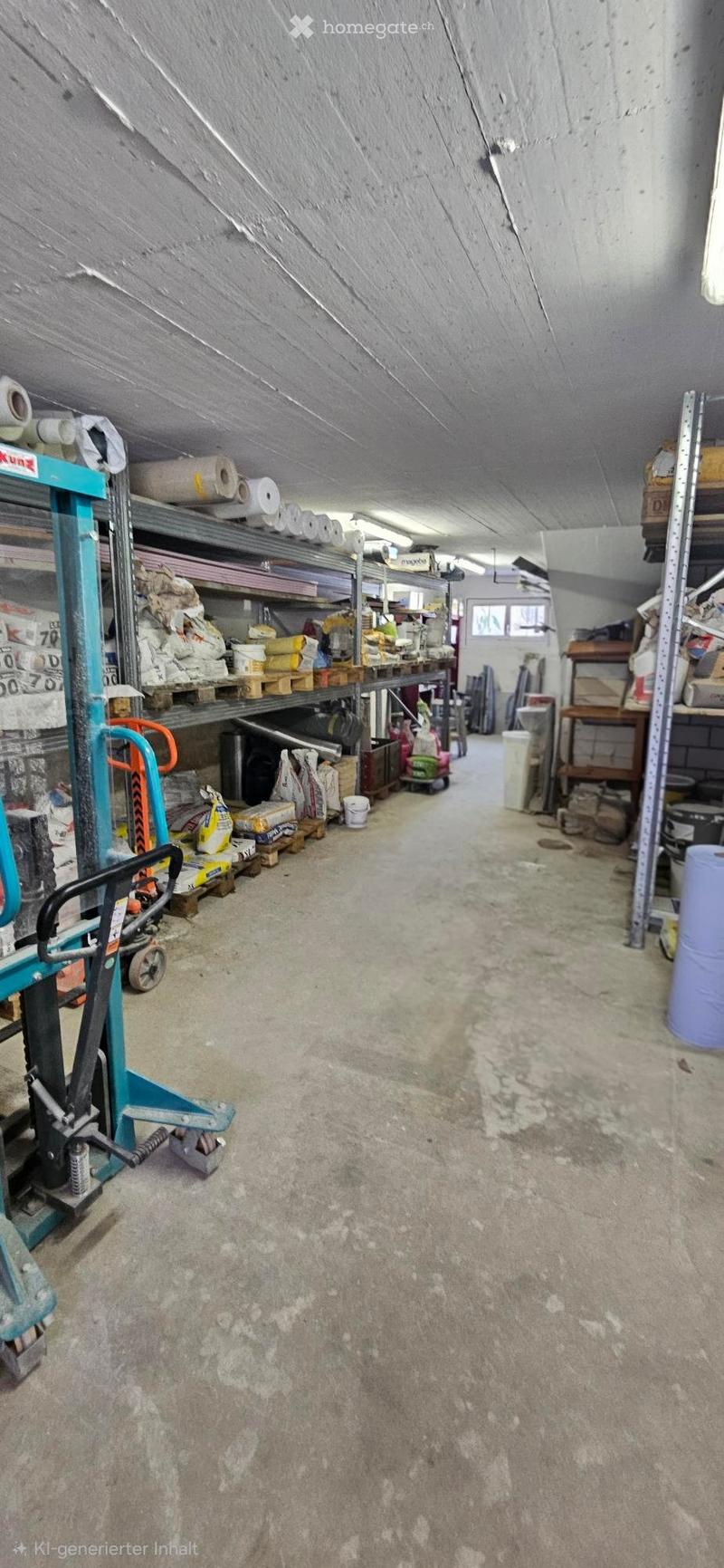 A spacious, unfinished storage area with concrete floors, metal shelving units, and various construction materials and tools stored on pallets and shelves.