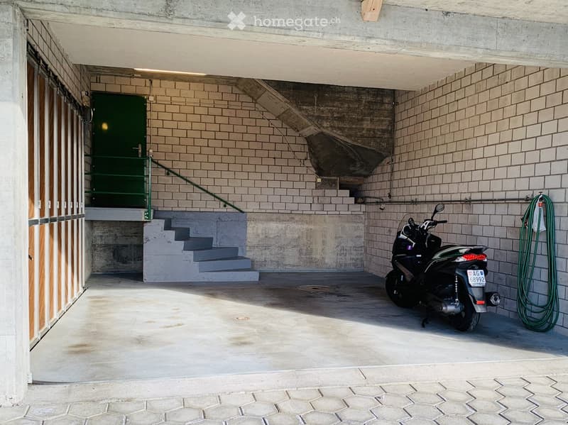 {"type": "Garage", "objects": ["motorcycle"], "description": "Underground garage with concrete walls, tiled steps leading up, and a parked motorcycle.", "localized_descriptions": {"EN": "Underground garage with concrete walls, tiled steps leading up, and
