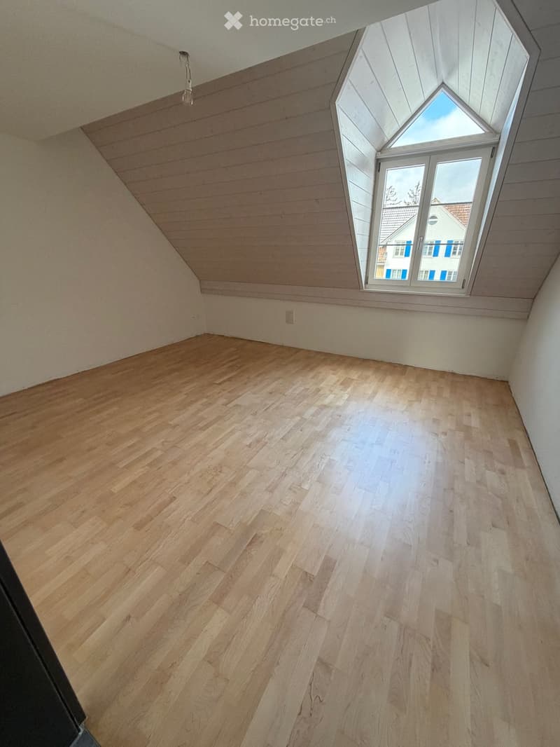 Hardwood flooring, slanted ceiling, window