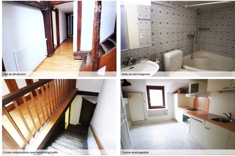 The image shows a hallway with wooden flooring, white walls, and a staircase leading upwards. The hallway appears to be part of a residential property, with a wooden railing and a door visible at the end.