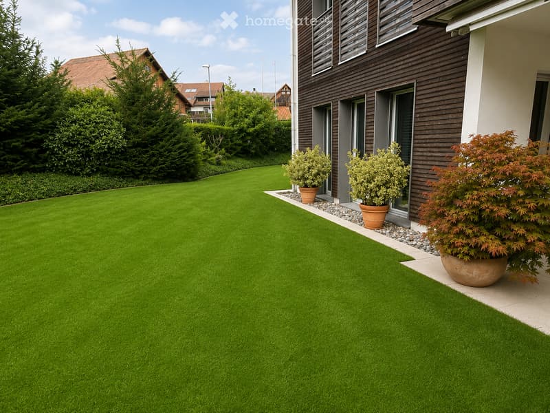 Well-maintained artificial grass lawn with a modern house in the background, featuring potted plants near the entrance.