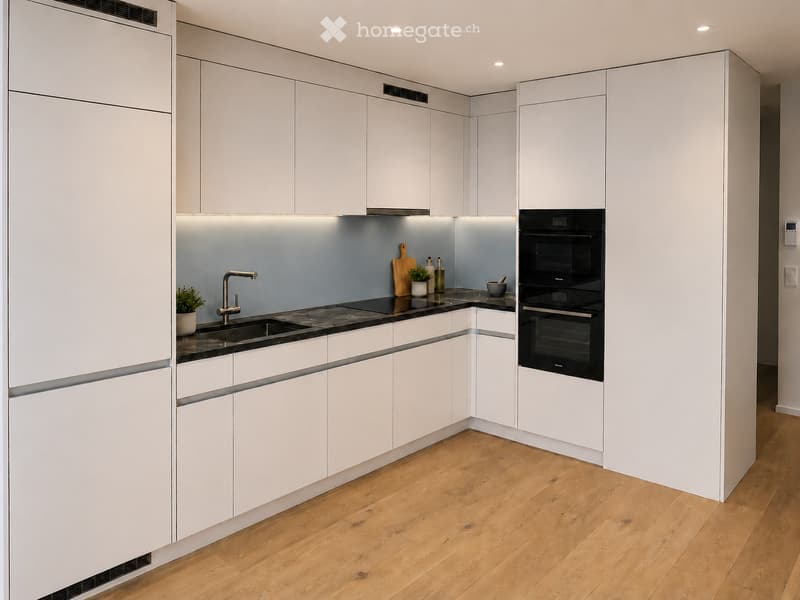 Modern kitchen with white cabinets, wooden flooring, and built-in appliances including a sink, faucet, oven, and countertop items.