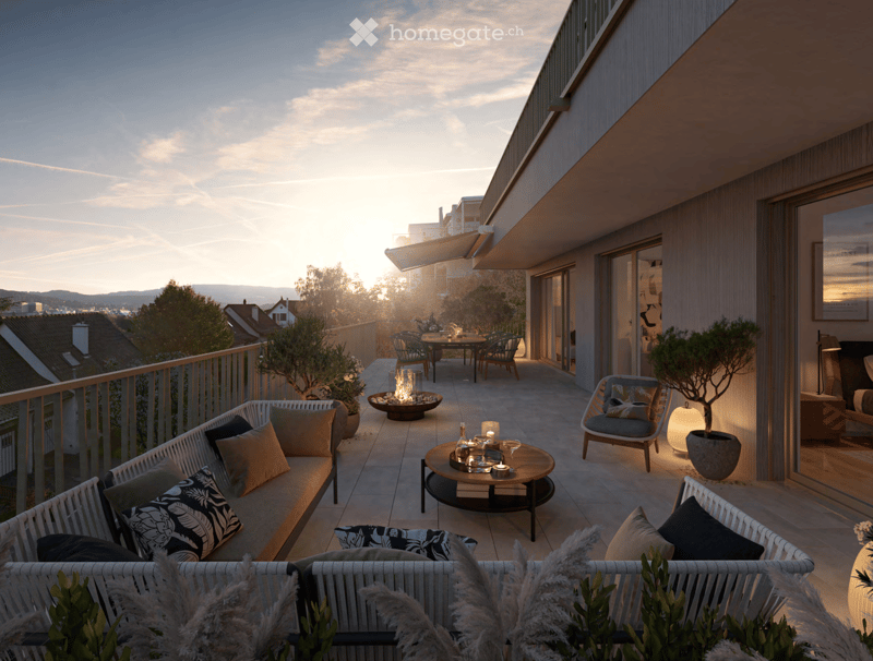 Modern rooftop terrace with a sofa, coffee table, chairs, a fire pit, and potted plants, overlooking a cityscape at sunset.
