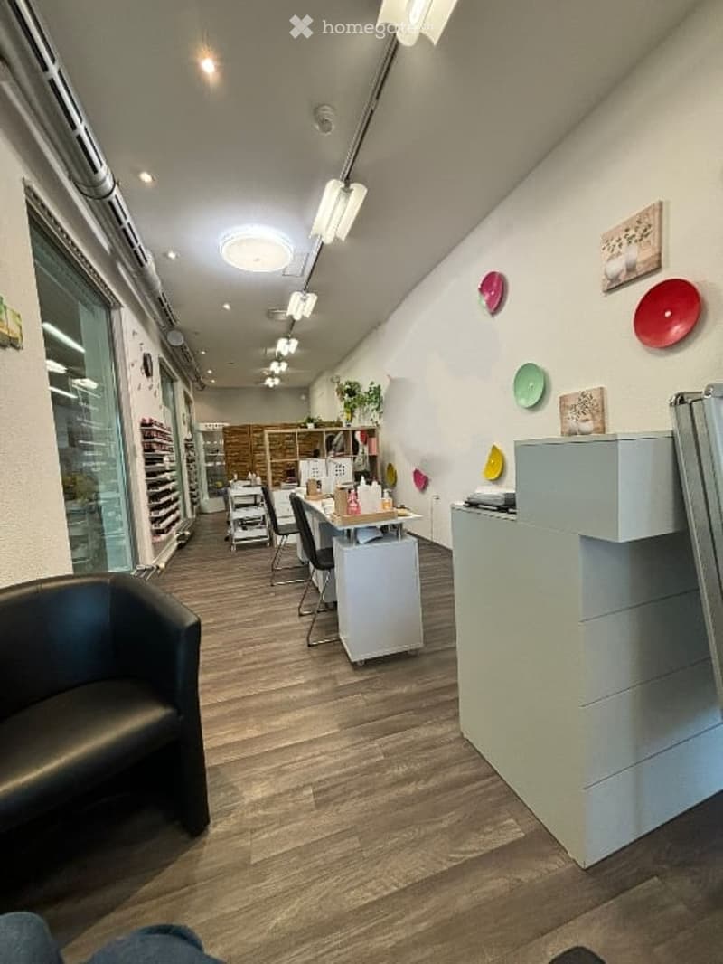 Interior of a salon, reception desk, chairs, table, and decorative items