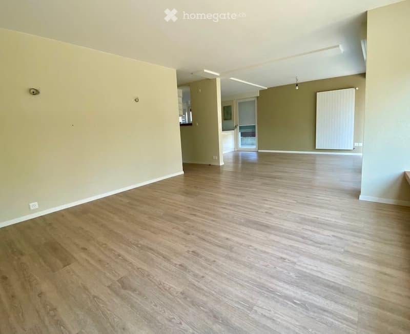 Empty room with light wooden flooring and neutral-colored walls. No furniture or equipment visible.