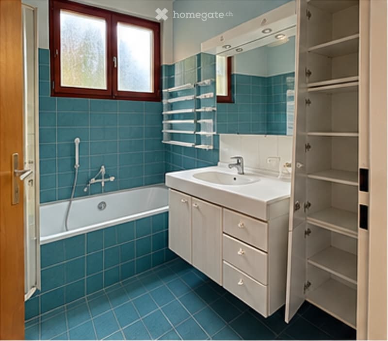 Bathroom with blue tiles, a bathtub, a sink with a mirror, and open shelves.
