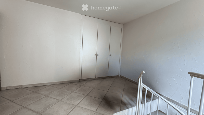 Empty room with tiled floor, white walls, and a white closet. No furniture or equipment present.