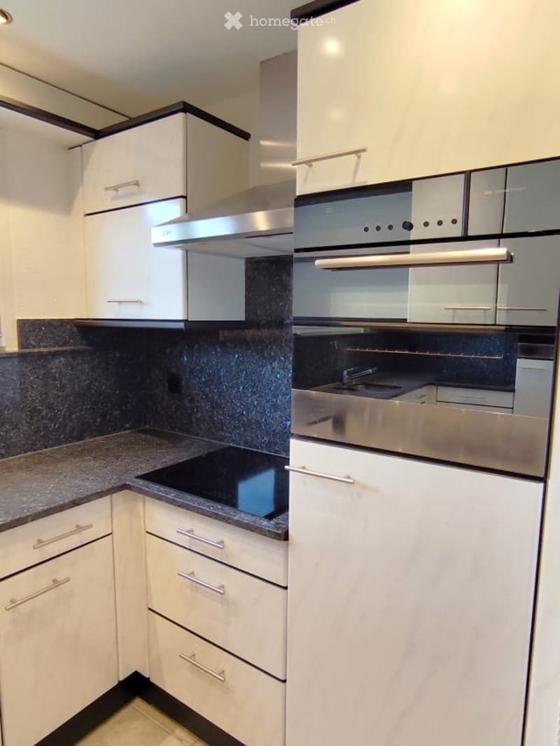 modern kitchen with white cabinets, granite countertops, stainless steel appliances, gas stove, oven, sink, and dishwasher