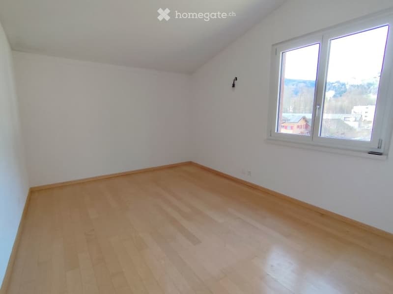 empty room, wooden floor, white walls, large window, power outlet