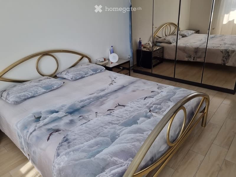 Bedroom with a bed, nightstands, and a mirror.