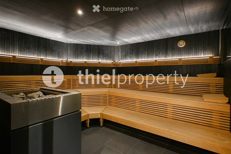 a sauna with wooden benches and a stove