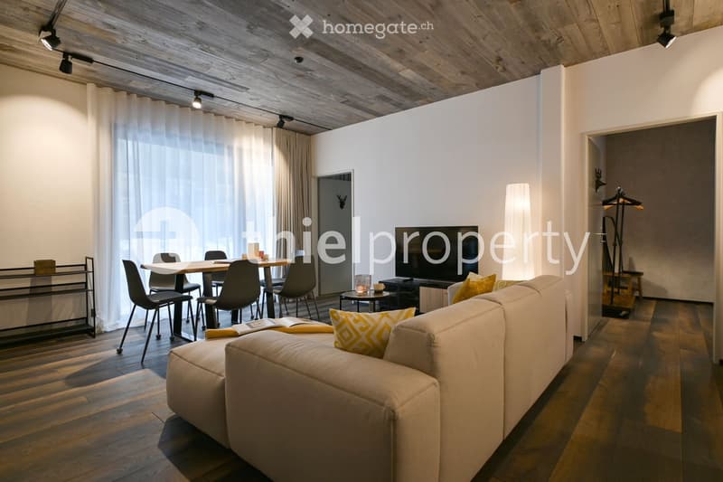 modern living room with dining area, couch, TV, table with chairs, wooden floor, white walls, wooden ceiling, track lighting