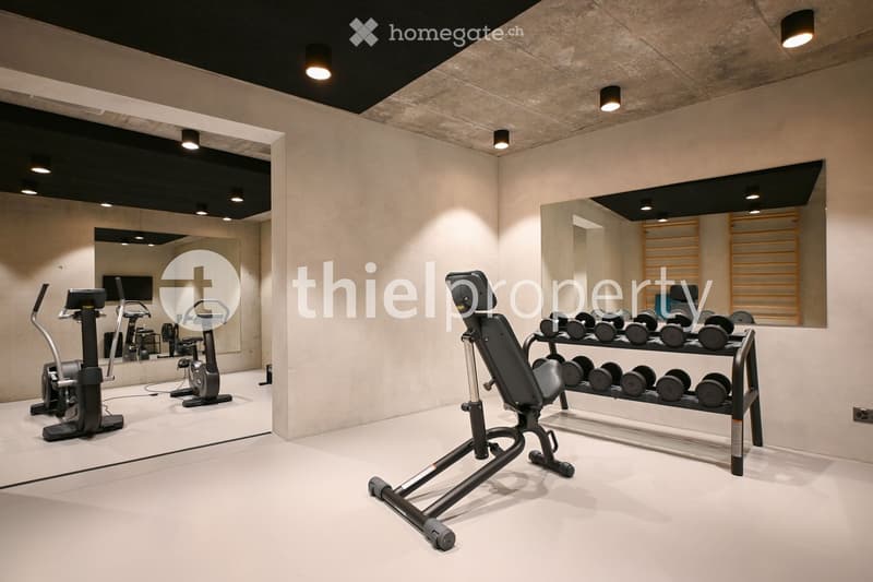 Home gym with workout equipment, mirror, and track lighting