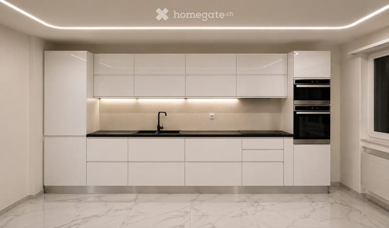 Modern kitchen with white cabinets, marble flooring, built-in oven, and sleek lighting.