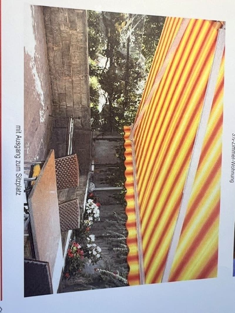 A narrow outdoor pathway lined with colorful striped awnings and small potted plants, creating a vibrant and inviting atmosphere.