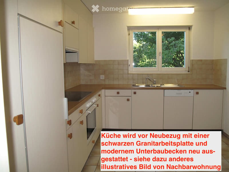 Modern kitchen with white cabinets, wooden countertops, sink, faucet, oven, and dishwasher. Features a window with a view of greenery.