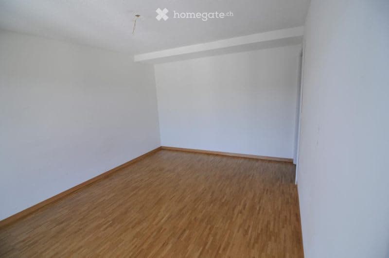empty room with wooden floor and white walls