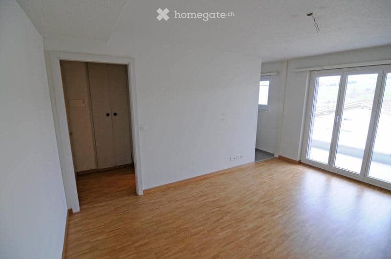 wooden floor, glass sliding doors, windows, door to another room, empty