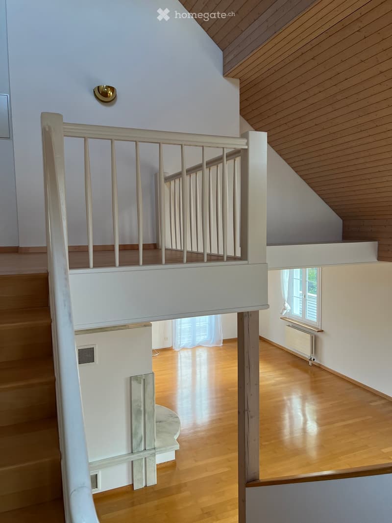 Wooden floor, white wall, stairs, wooden ceiling, window with white curtain, radiator
