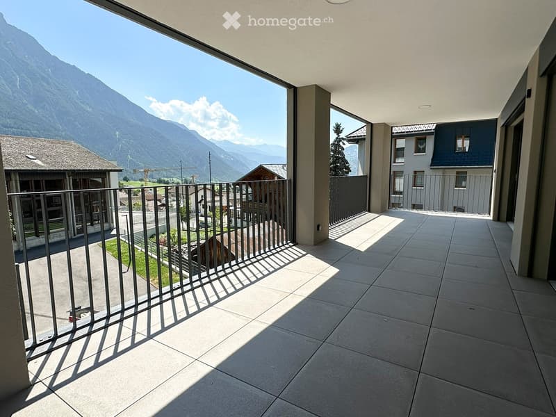 Balcony with tiled floor, metal railing, and scenic mountain view.