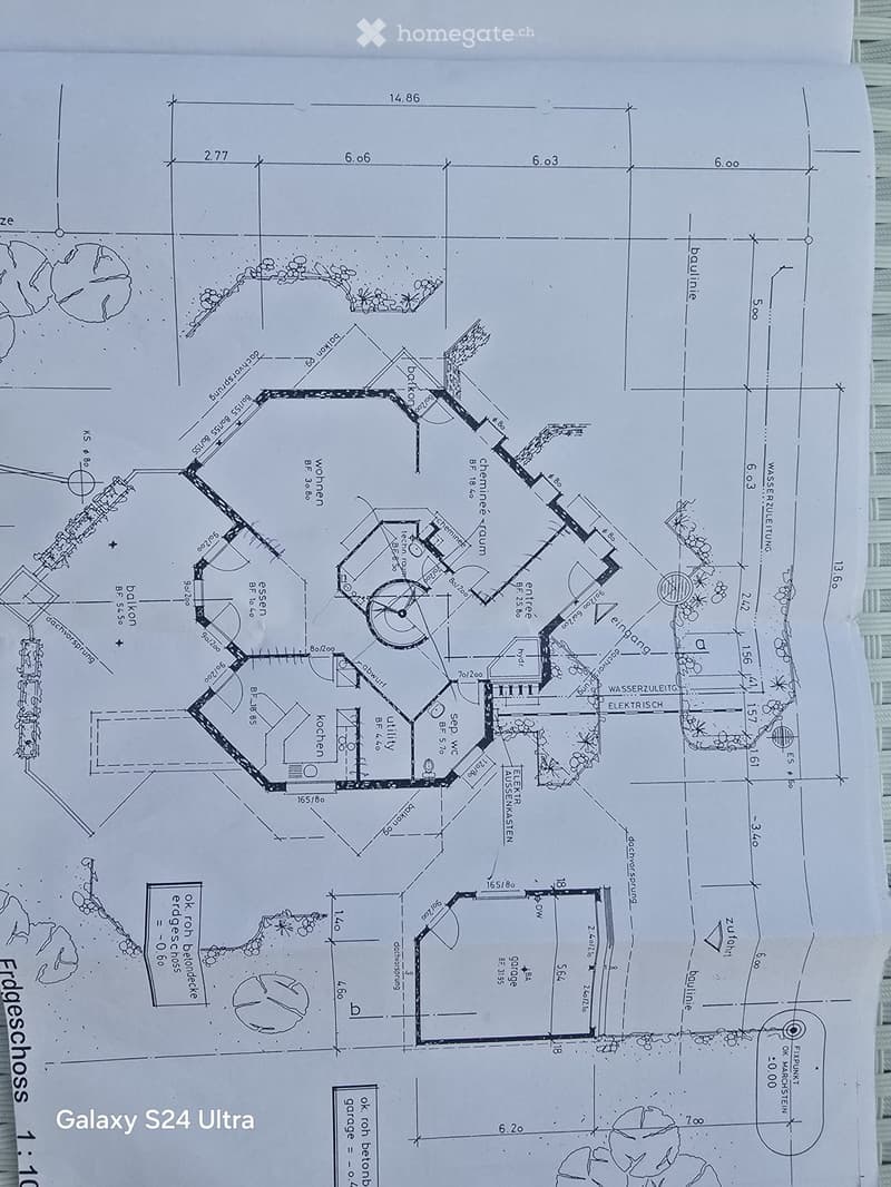 Floor plan of a house showing living room, kitchen, bedrooms, bathrooms, and utility area. Includes measurements and labels for various rooms and spaces.