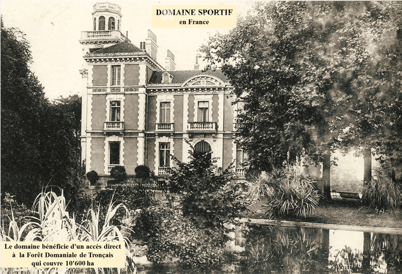 A large, multi-story mansion with classical architecture, featuring arched windows, balconies, and ornate detailing, surrounded by lush greenery and trees.