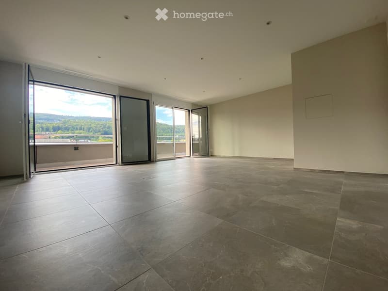 Empty room with large sliding glass doors leading to a balcony, tiled floor, and neutral-colored walls.