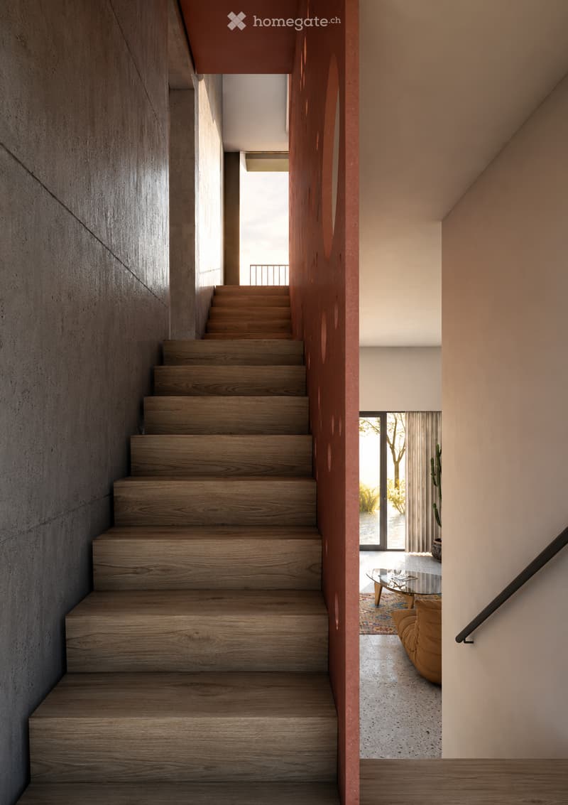 Modern hallway with wooden staircase, glass door leading to outdoor area, visible living room with sofa, coffee table, and rug.