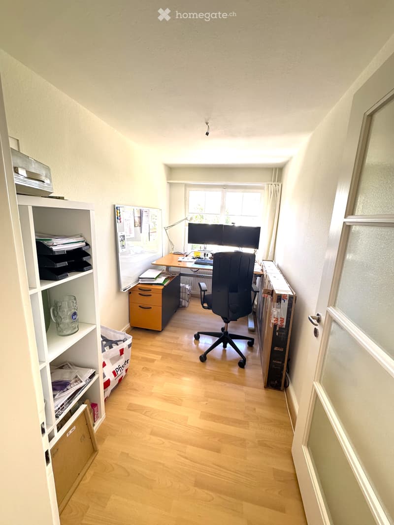Empty room with wooden ceiling, white walls, and a window letting in natural light. No furniture or equipment is present.