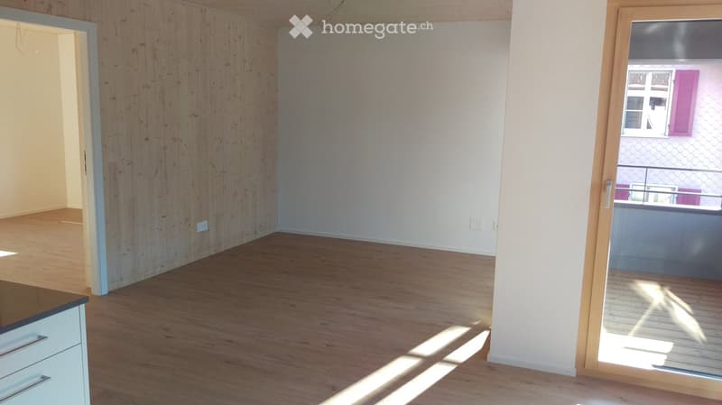 Empty room, wooden floor, white walls, open balcony