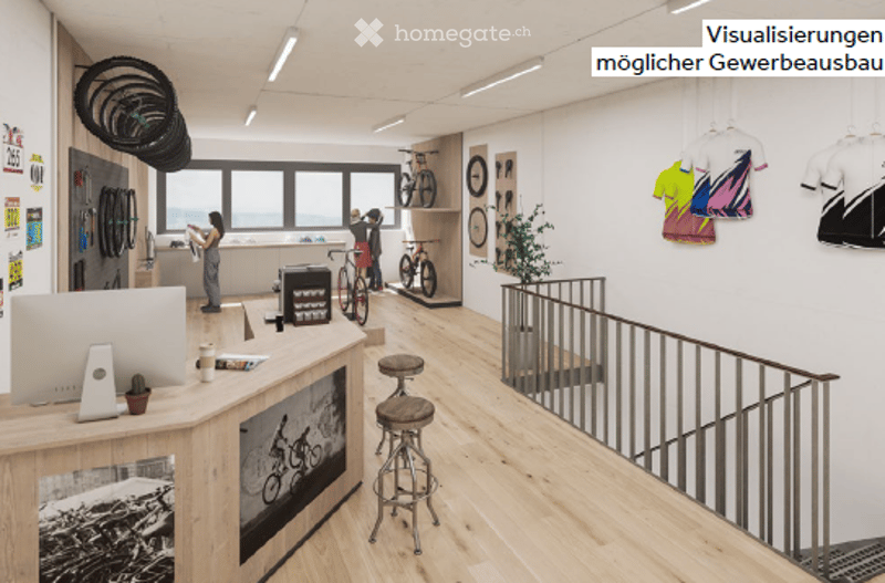 Modern, open-plan office or showroom with large windows offering a view, wooden flooring, a reception desk, two stools, bicycles, and a potted plant.