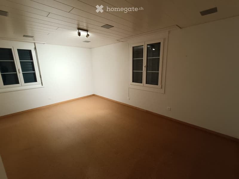 empty room, white walls, wooden floors, two windows, no furniture