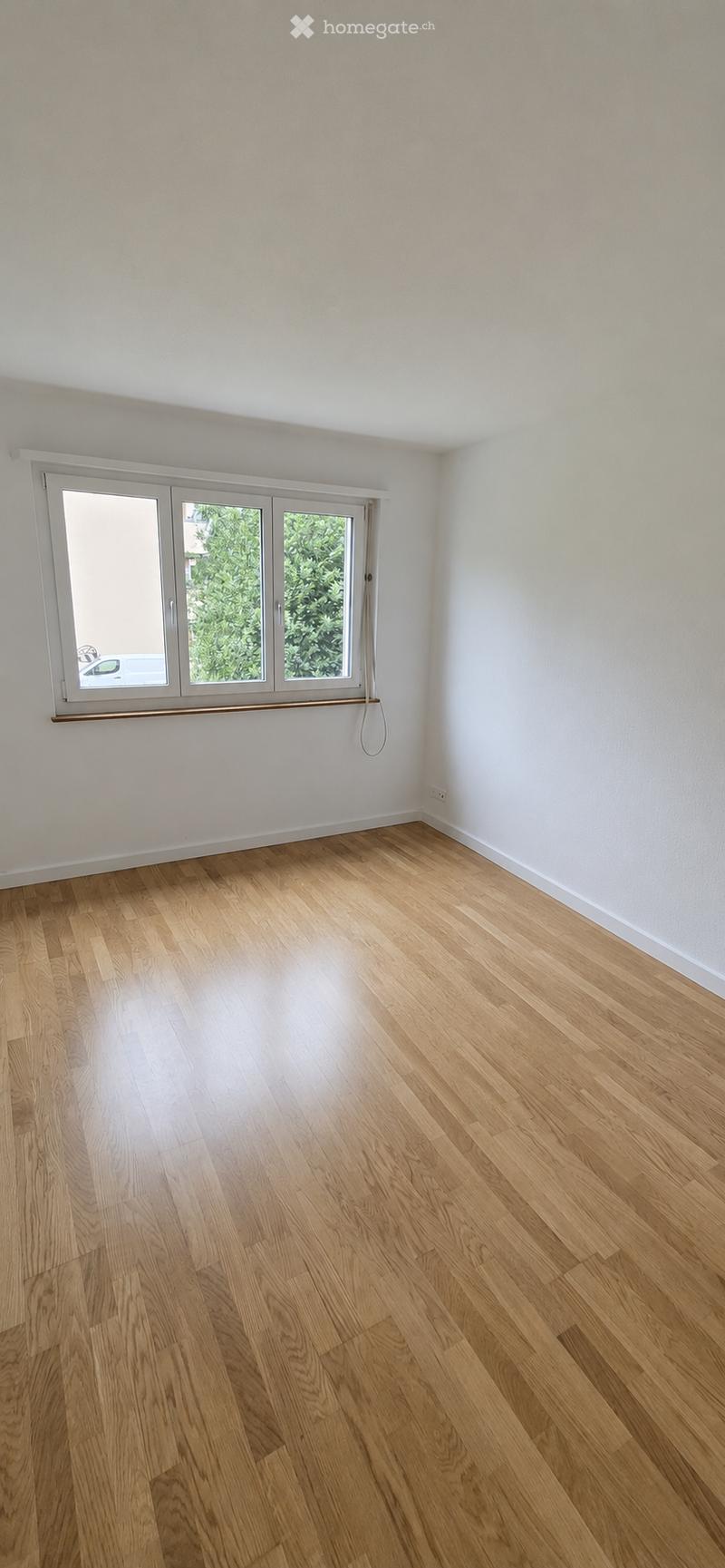 Completely empty room with bare walls and wooden floor. No furniture or equipment.