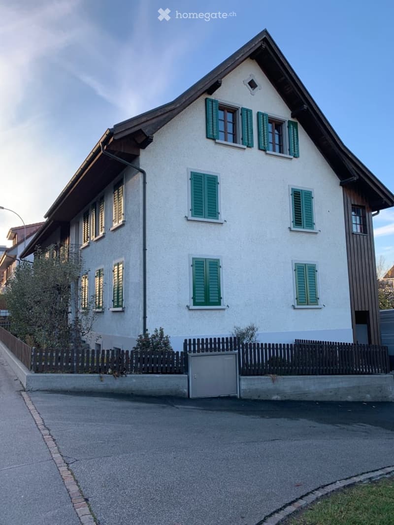 3 story house, white exterior, green shutters, wooden fence, driveway
