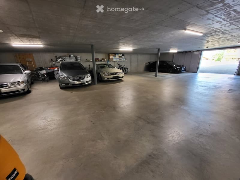 {"visible_features": ["Garage"], "type": "Garage", "objects": [], "description": "Underground garage with multiple parked cars, concrete floor, and storage shelves on the left side.", "localized_descriptions": {"EN": "Underground garage with multiple park