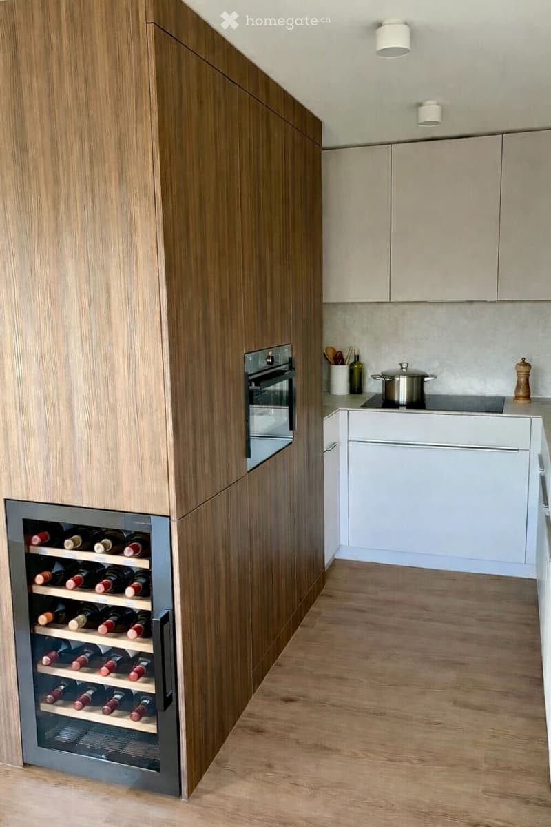kitchen area with wooden cabinets, built-in wine cooler, white countertops, gas stove, white ceiling lamps