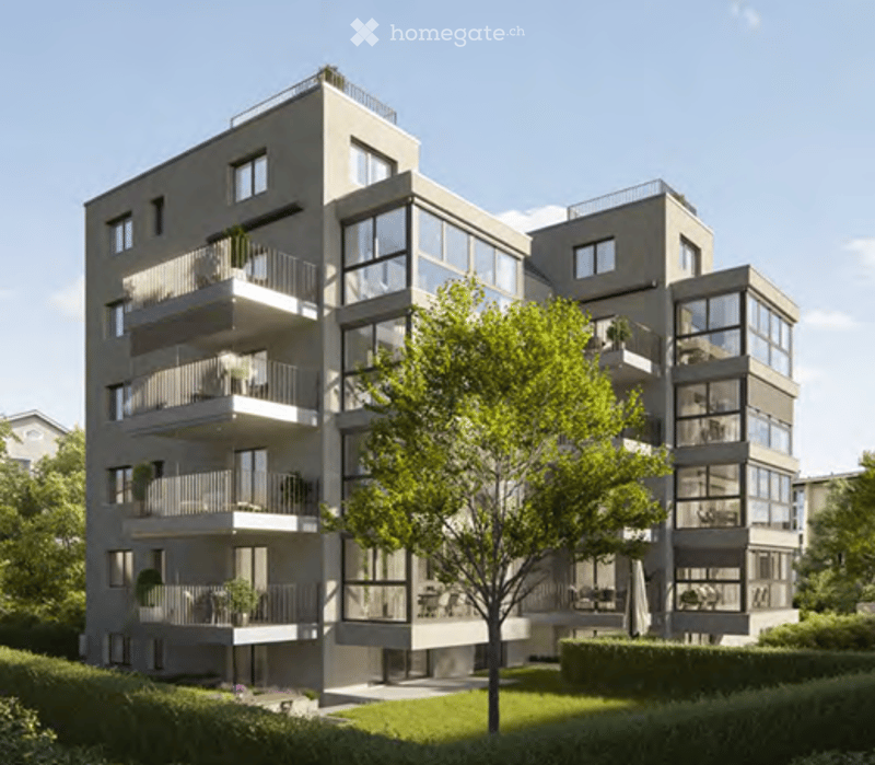 Modern multi-story apartment building with large windows and balconies, surrounded by greenery and a small tree in the foreground.