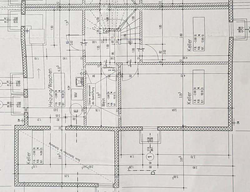 Floor plan showing a multi-level building layout with labeled rooms including a heating/washing area, cellar, and various dimensions.