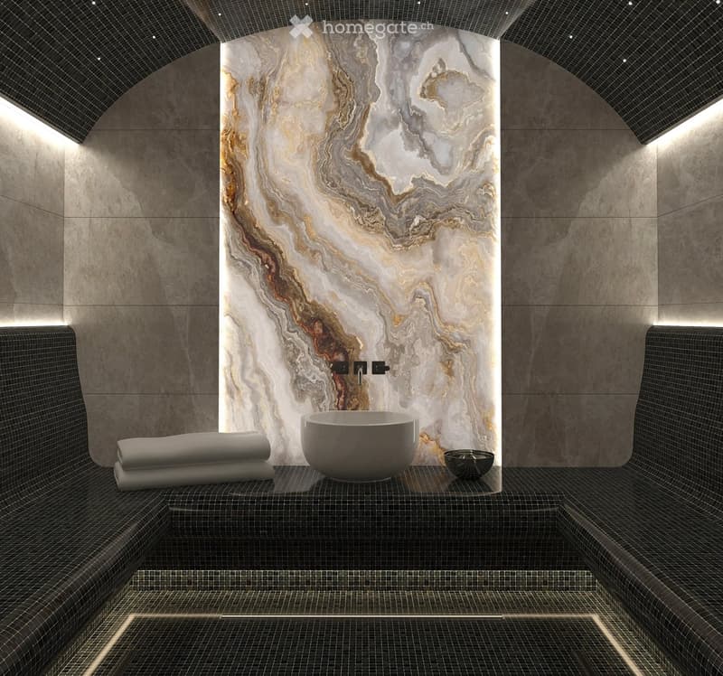 Spa-like bathroom with marble wall, modern sink, and neatly folded towels on the bench.