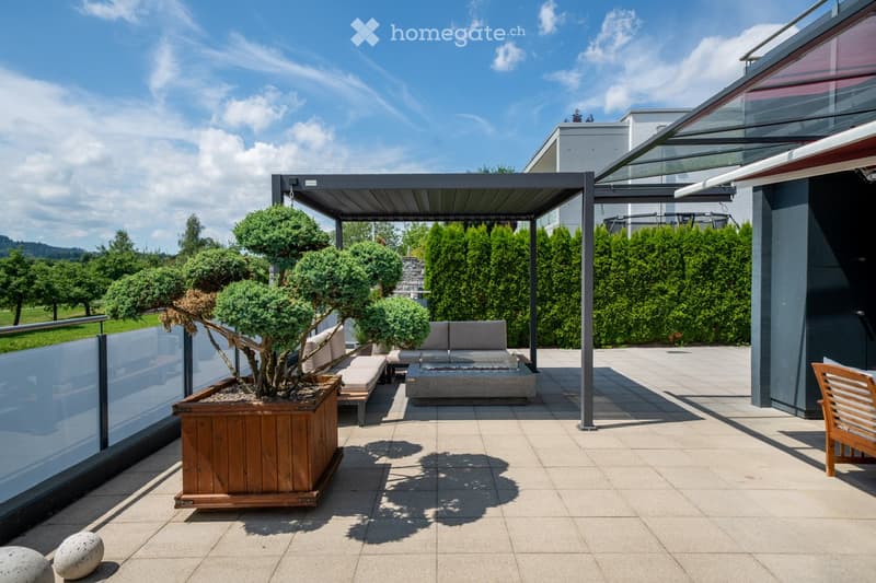 covered patio with a wooden pergola, sitting area, and a firepit with seating