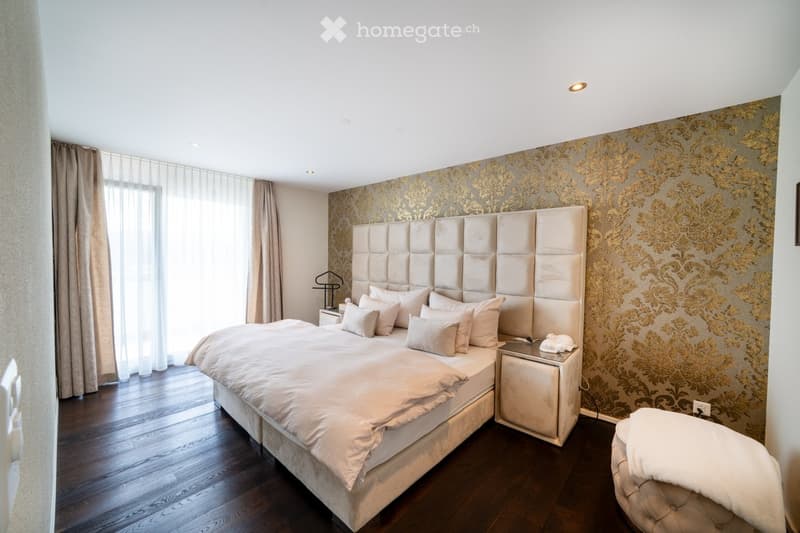 Bedroom with bed, pillows, night stands, and rug