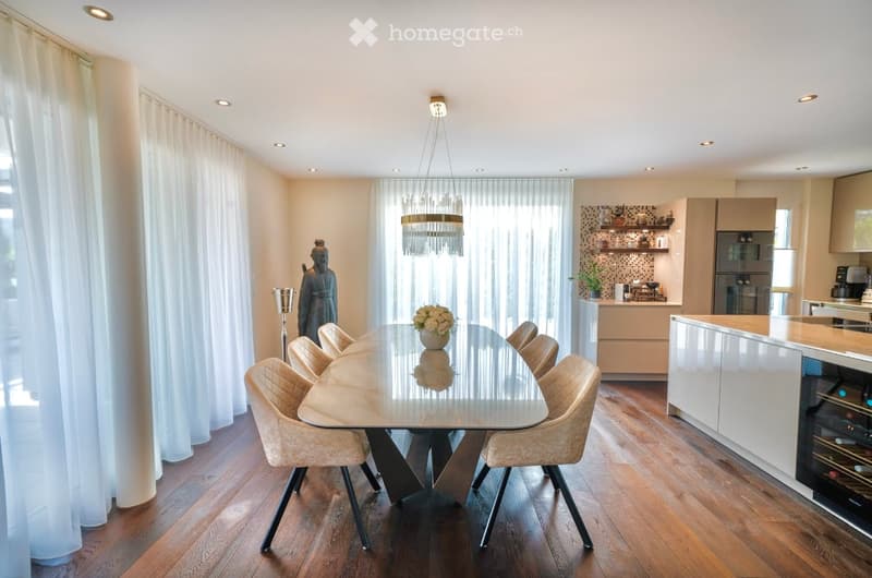 Dining table with chairs, chandelier, white wall, white curtains, parquet floor