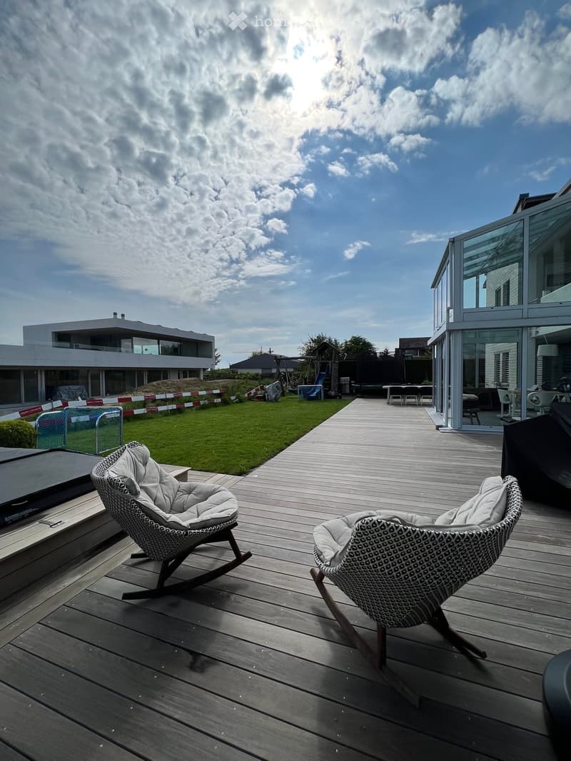 {"visible_features": [], "type": "Garden / Outdoor Area", "objects": ["chair", "chair", "table", "chairs", "table", "lamp", "slide", "trampoline", "fence", "fence", "fence", "fence", "fence", "fence", "fence", "fence", "fence", "fence", "fence", "fence",
