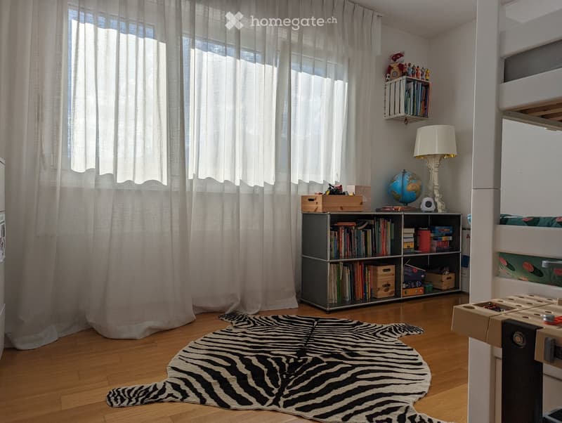{"visible_features": [], "type": "Room", "description": "white walls, large window, white curtains, bookshelf, lamp, zebra rug, bunk beds"}